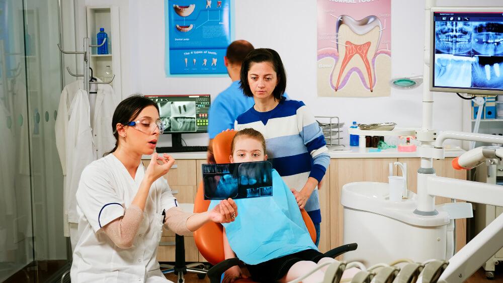a kid and her mom learning about oral health